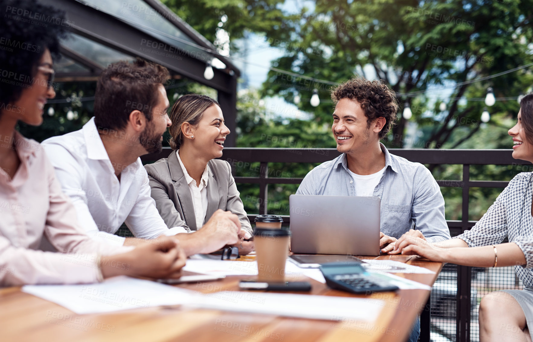 Buy stock photo Cropped shot of a diverse group of businesspeople sitting together and having a meeting outside the office