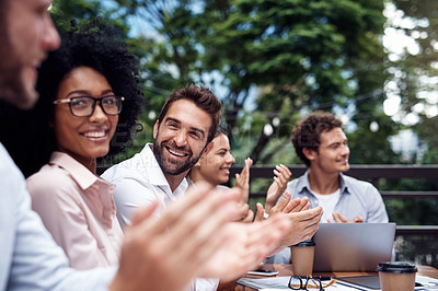 Buy stock photo Cropped shot of a diverse group of businesspeople sitting together and clapping after a successful meeting in outdoors
