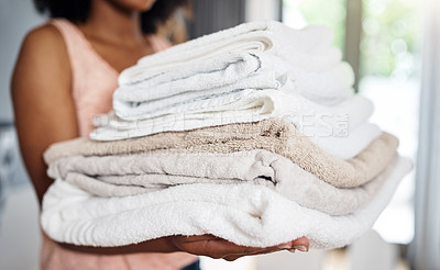 Buy stock photo Cropped shot of an unrecognizable woman carrying clean towels art home