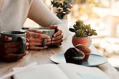 Buy stock photo Cropped shot of an unrecognizable woman having coffee and muffins with her female friend at a coffee shop