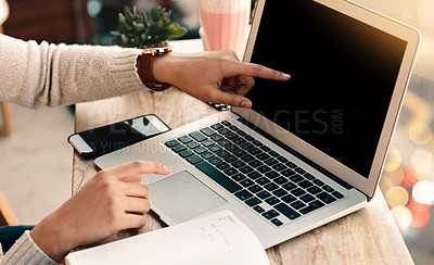 Buy stock photo Cropped shot of an unrecognizable woman pointing at the screen of her laptop while sitting at a cafe during the day
