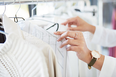 Buy stock photo Cropped shot of an unrecognizable woman looking through a railing of clothing in a boutique