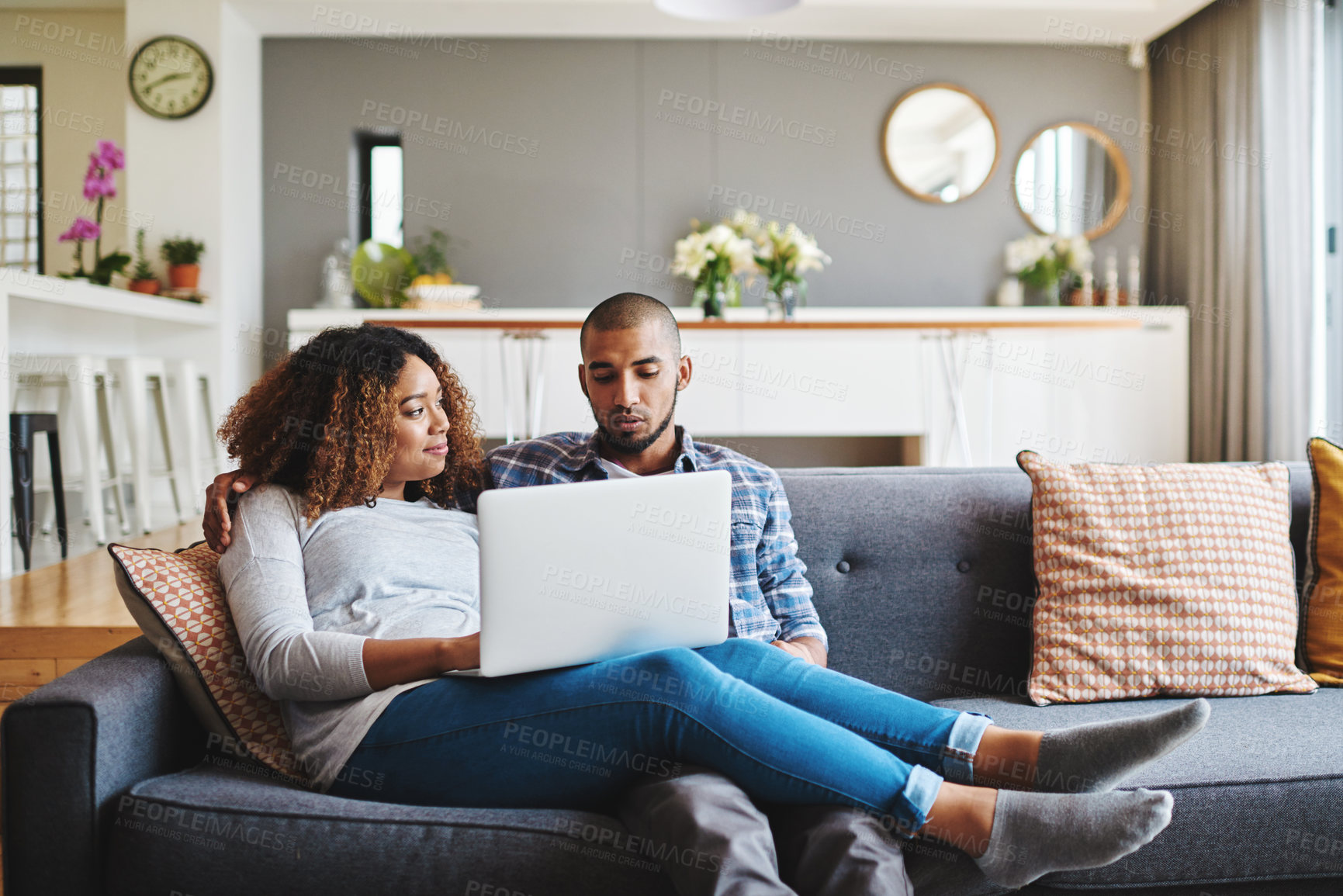 Buy stock photo A relaxed couple on sofa watching movie on laptop or browsing internet for a romantic afternoon indoors. Casual, young and in love boyfriend and girlfriend bonding while searching the web on laptop 