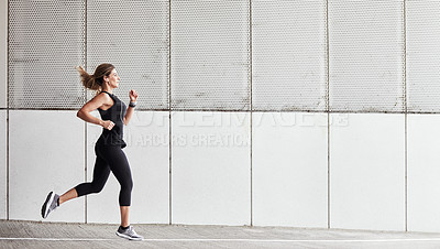 Buy stock photo Portrait of a sporty young woman running outdoors