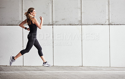 Buy stock photo Portrait of a sporty young woman running outdoors