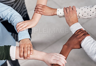 Buy stock photo Cropped shot of a group of businesspeople linking their arms in solidarity