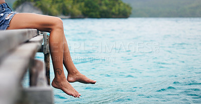 Buy stock photo Feet, lake and travel with a woman outdoor on a calm deck to relax with peace, water and mockup space. Female person with Africa tattoo on legs and freedom on vacation, holiday or adventure in nature