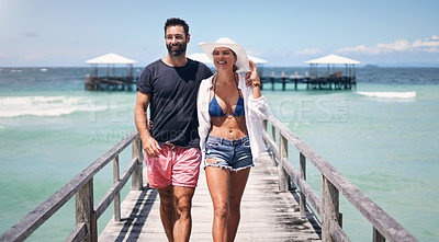 Buy stock photo Beach, island and couple walking on deck for holiday, summer vacation and tropical weekend in Maldives. Love, travel and happy man and woman on luxury resort for honeymoon, anniversary and adventure