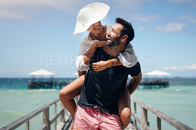 Buy stock photo Couple, piggyback and beach deck on a tropical island with love and laughing on holiday. Summer vacation, travel smile and Maldives walk in nature with freedom and happiness by the ocean and sea