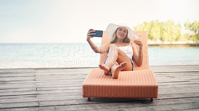 Buy stock photo Young woman, lounge selfie and cocktail on holiday by the ocean on a deck chair with a smile. Female person, travel and Maldives island in summer taking a photo for a profile picture and social media