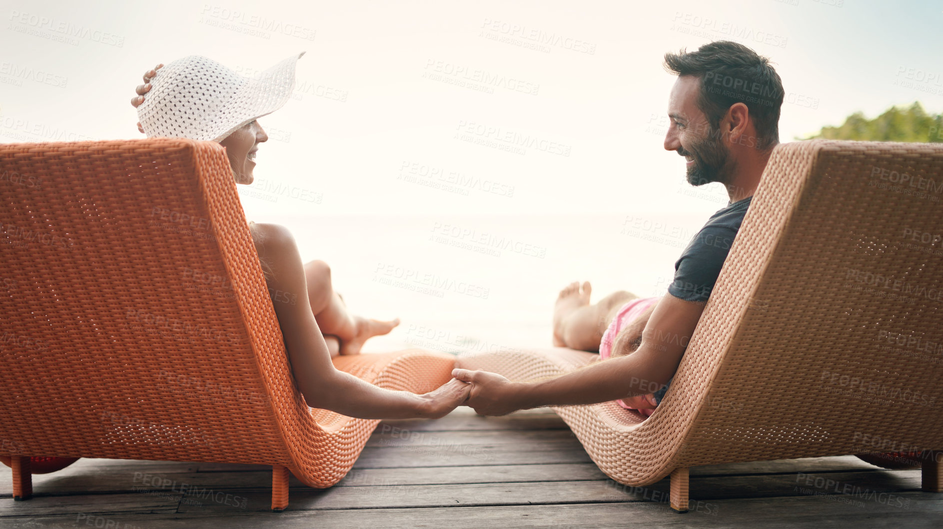 Buy stock photo Relax, travel and deck with couple holding hands at hotel resort for bonding, luxury and summer vacation. Honeymoon, happy and tropical with man and woman at Bali villa for date, holiday and mockup