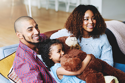 Buy stock photo Cropped shot of a happy young family of three relaxing together in their living room at home