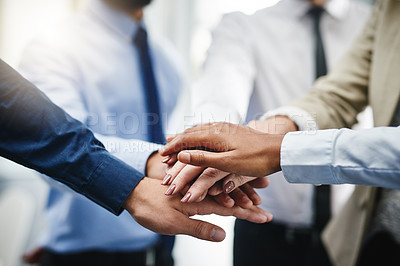 Buy stock photo Cropped shot of an unrecognizable group of businesspeople standing in the office together with their hands stacked