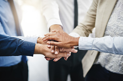 Buy stock photo Cropped shot of an unrecognizable group of businesspeople standing in the office together with their hands stacked