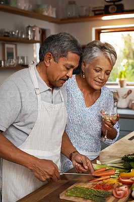 Buy stock photo Vegetables, cooking and old couple with wine in kitchen, healthy food and marriage time together in home for dinner. Drink, glass and senior woman with man, meal prep and wellness diet in retirement.