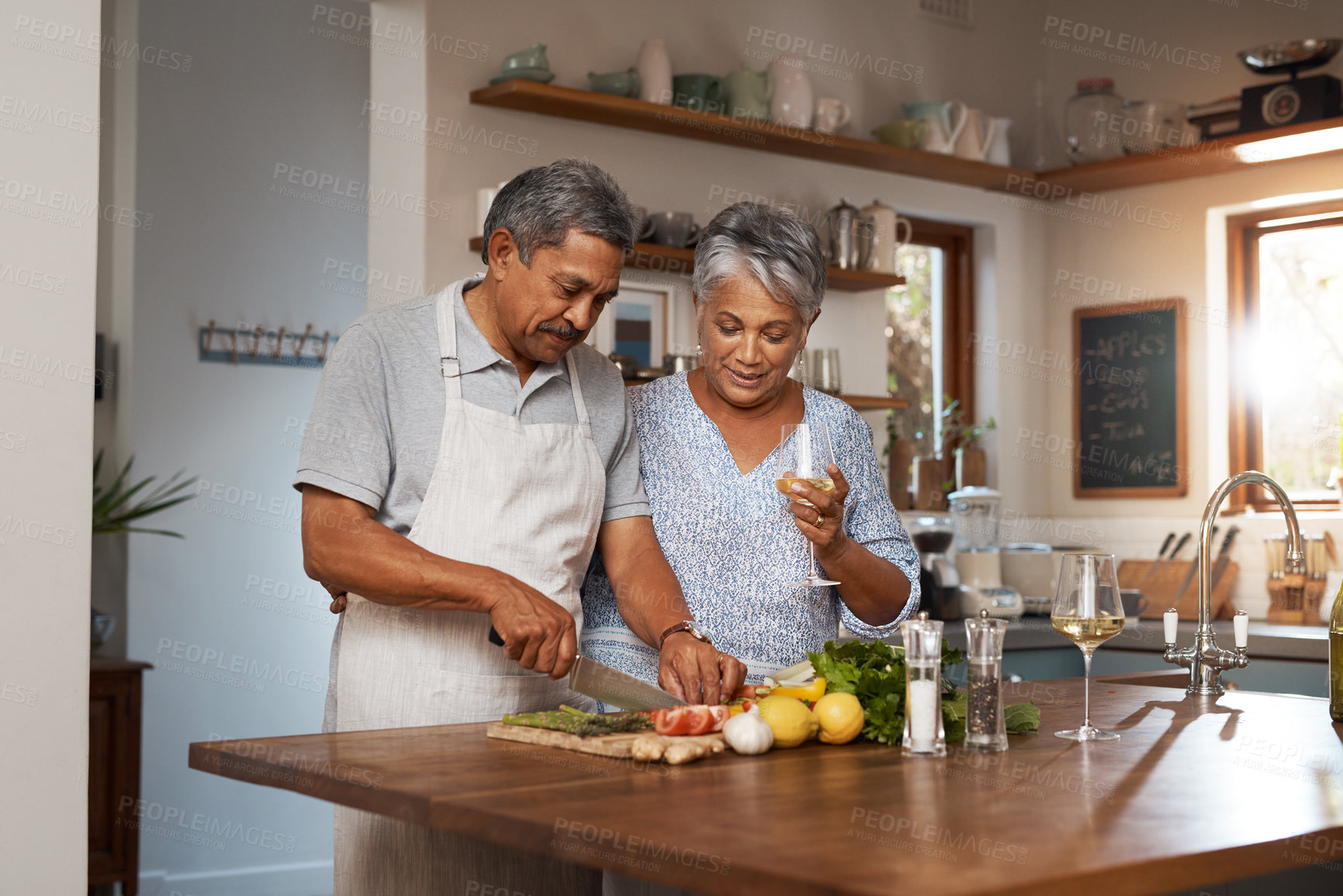 Buy stock photo Vegetables, cooking and senior couple with wine in kitchen, healthy food and marriage bonding together in home. Drink, glass and happy woman with old man, meal prep and wellness diet in retirement.