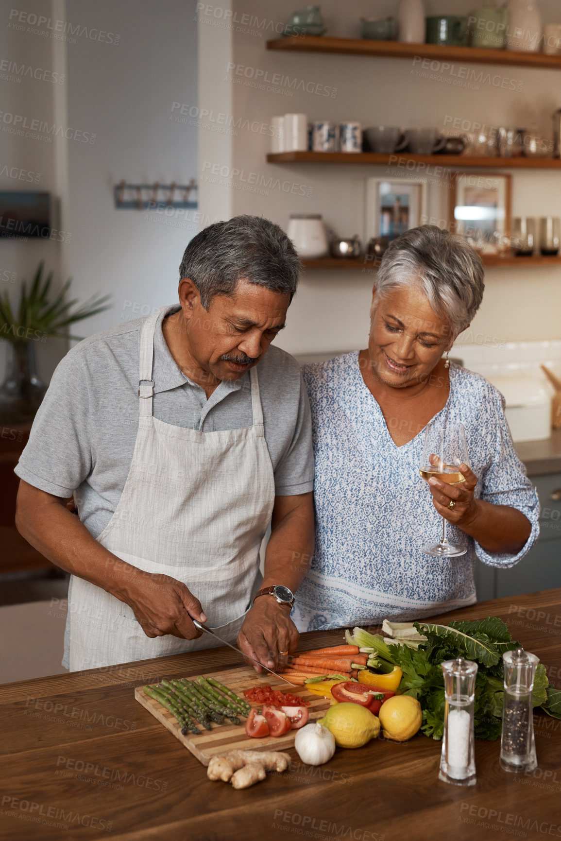 Buy stock photo Marriage, old man and woman with wine, cooking in kitchen and healthy food, bonding together in home. Drink, glass and vegetables, senior couple with vegetable meal prep and wellness in retirement.