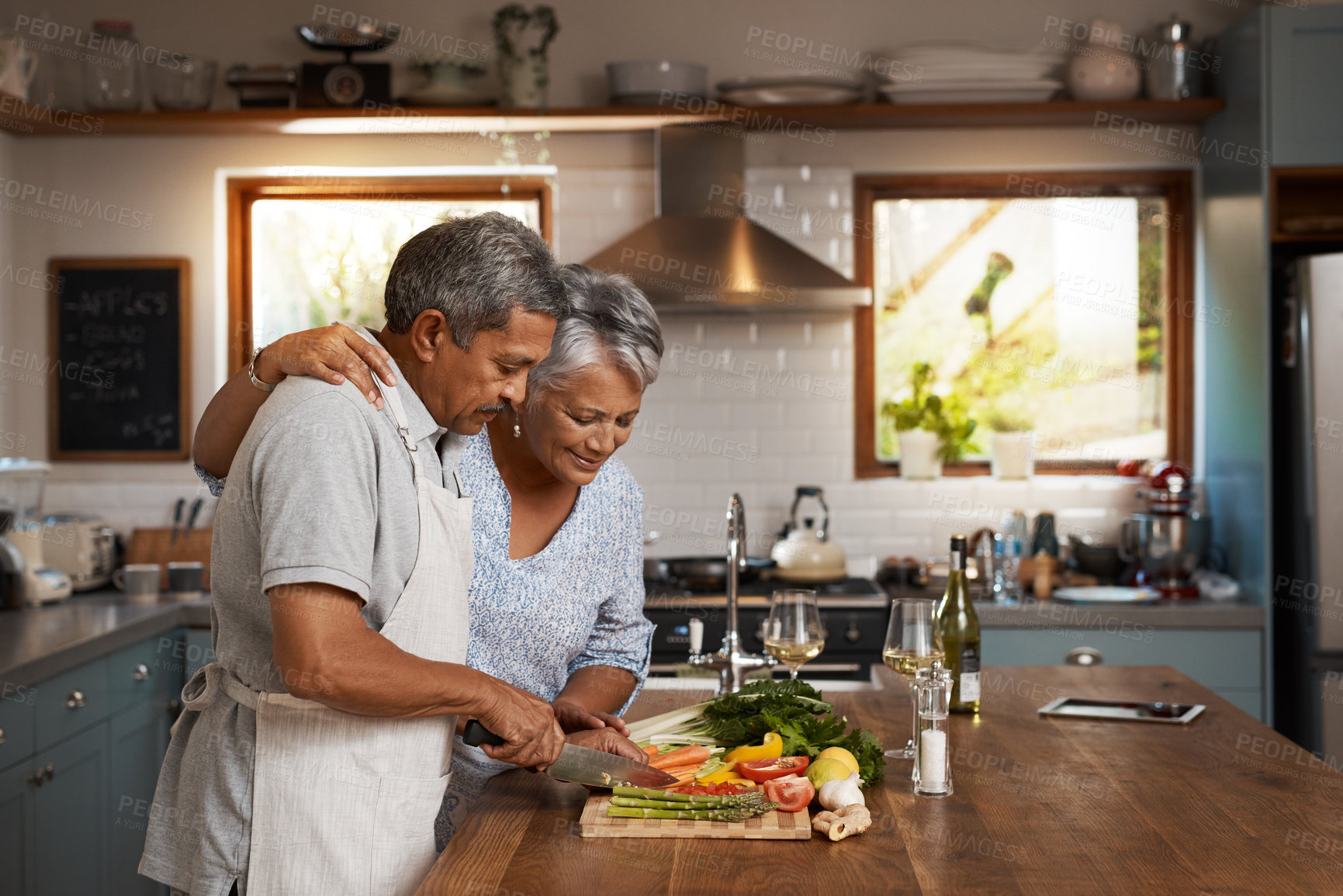 Buy stock photo Cooking, old man and woman with vegetables at kitchen counter, healthy food and marriage bonding in home. Salad, help and dinner, senior couple with happiness, vegetable meal prep and retirement diet