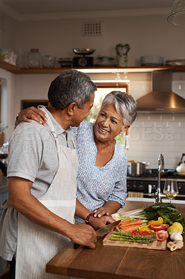 Buy stock photo Happiness, vegetables and old man with woman in kitchen, embrace and healthy marriage bonding in home for dinner. Love, help and cooking, senior couple with smile, hug and happy time in retirement.