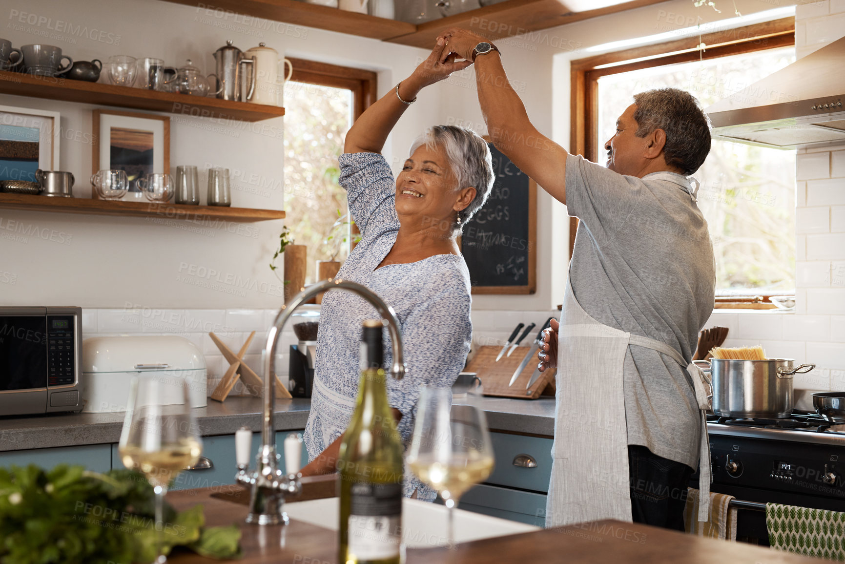 Buy stock photo Dancing, spin and senior couple in kitchen for bonding, loving relationship and romance together in home. Retirement, marriage and happy mature man and woman for cooking meal, lunch and dinner