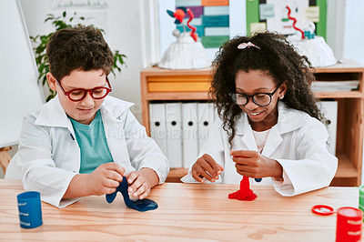 Buy stock photo Shot of two adorable school pupils playing and experimenting with slime in science class at school