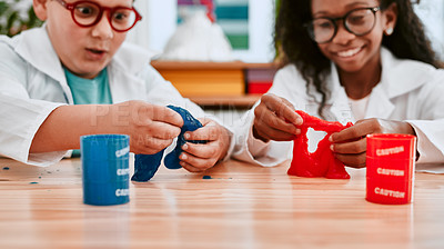 Buy stock photo Cropped shot of two adorable school pupils playing and experimenting with slime in science class at school