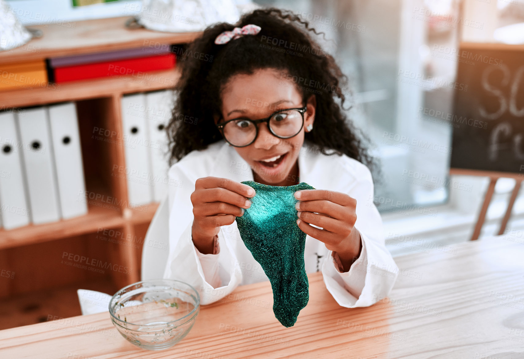 Buy stock photo Girl, learning and slime in classroom for science, surprise or lab coat with container at school. Child, green substance and education for chemical with wow for studying, excited and nerd at academy