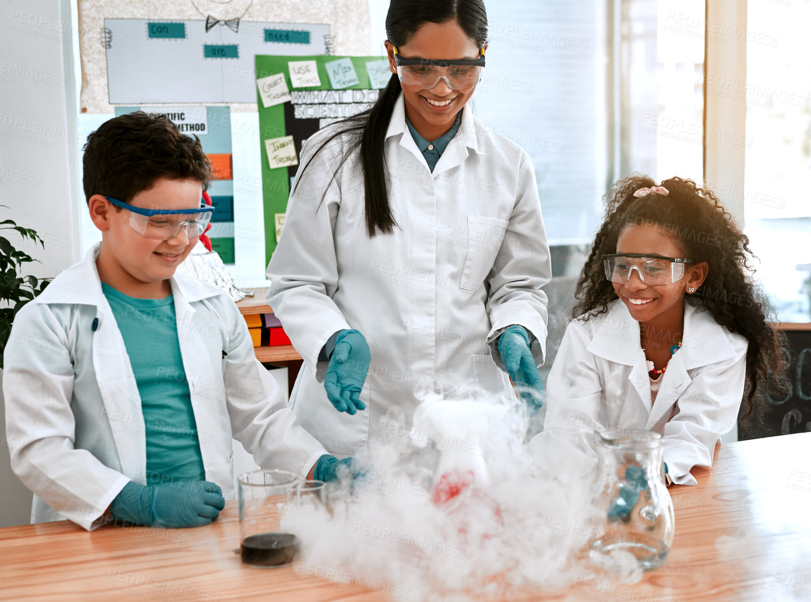 Buy stock photo Education, science or smoke with teacher and students at table in laboratory for experiment or reaction. Classroom, learning or study with woman scientist and children at school for development