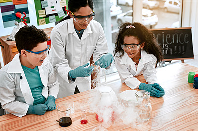 Buy stock photo Shot of an adorable little boy and girl conducting a scientific experiment with their teacher at school