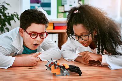 Buy stock photo Shot of an adorable little boy and girl building a robot in science class at school