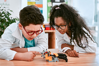 Buy stock photo Engineering, learning and children building a robot hand together in a classroom at school and being curious. Clever, education and young engineer students working in a science class doing research