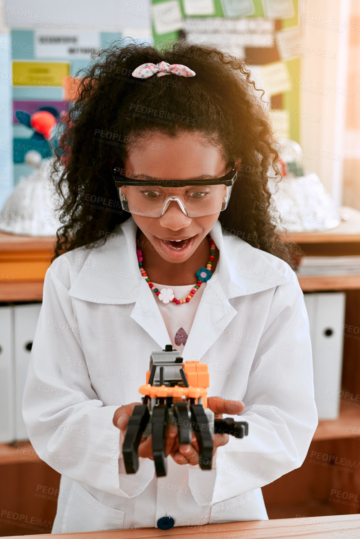 Buy stock photo Excited, education and girl with a robot, science class and innovation with progress, creativity and development. Female child, girl and student with technology, robotics and learning with excitement