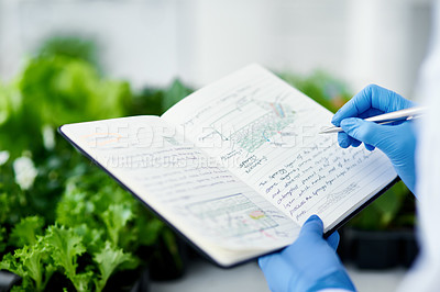 Buy stock photo Cropped shot of an unrecognizable scientist making notes