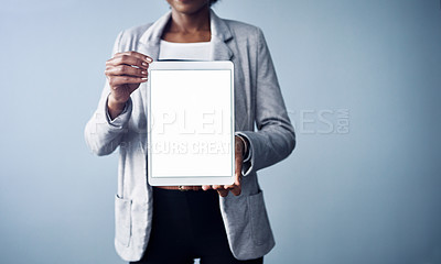 Buy stock photo Woman holding a white screen tablet looking professional mockup. Young and isolated black business corporate executive standing alone with blank digital device against a blue background copyspace