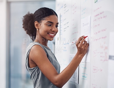 Buy stock photo Female leader, manager or boss giving a presentation, seminar or workshop during a meeting in the boardroom. Young business woman writing on a whiteboard while teaching a class in a corporate office