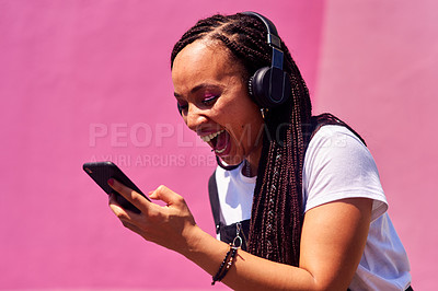 Buy stock photo Woman, pink background and happy winner with phone, celebrate for success with internet. Female person, mobile and headphones with laugh in studio, wow for victory with online game in New York