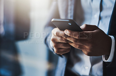 Buy stock photo Closeup shot of an unrecognizable businessman using a cellphone in an office