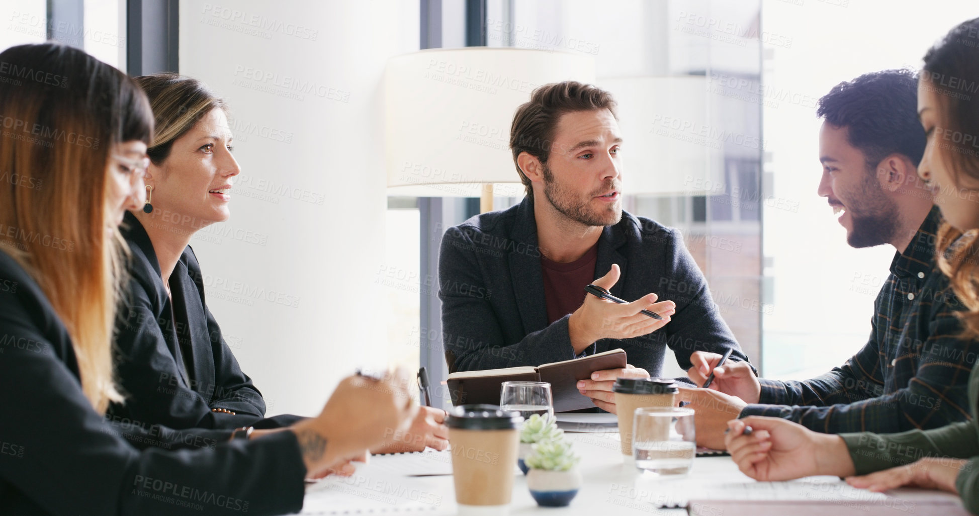 Buy stock photo Shot of a group of businesspeople having a meeting in a boardroom