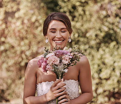 Buy stock photo Cropped shot of a beautiful young bride smiling while standing with a bouquet in her hands on her wedding day