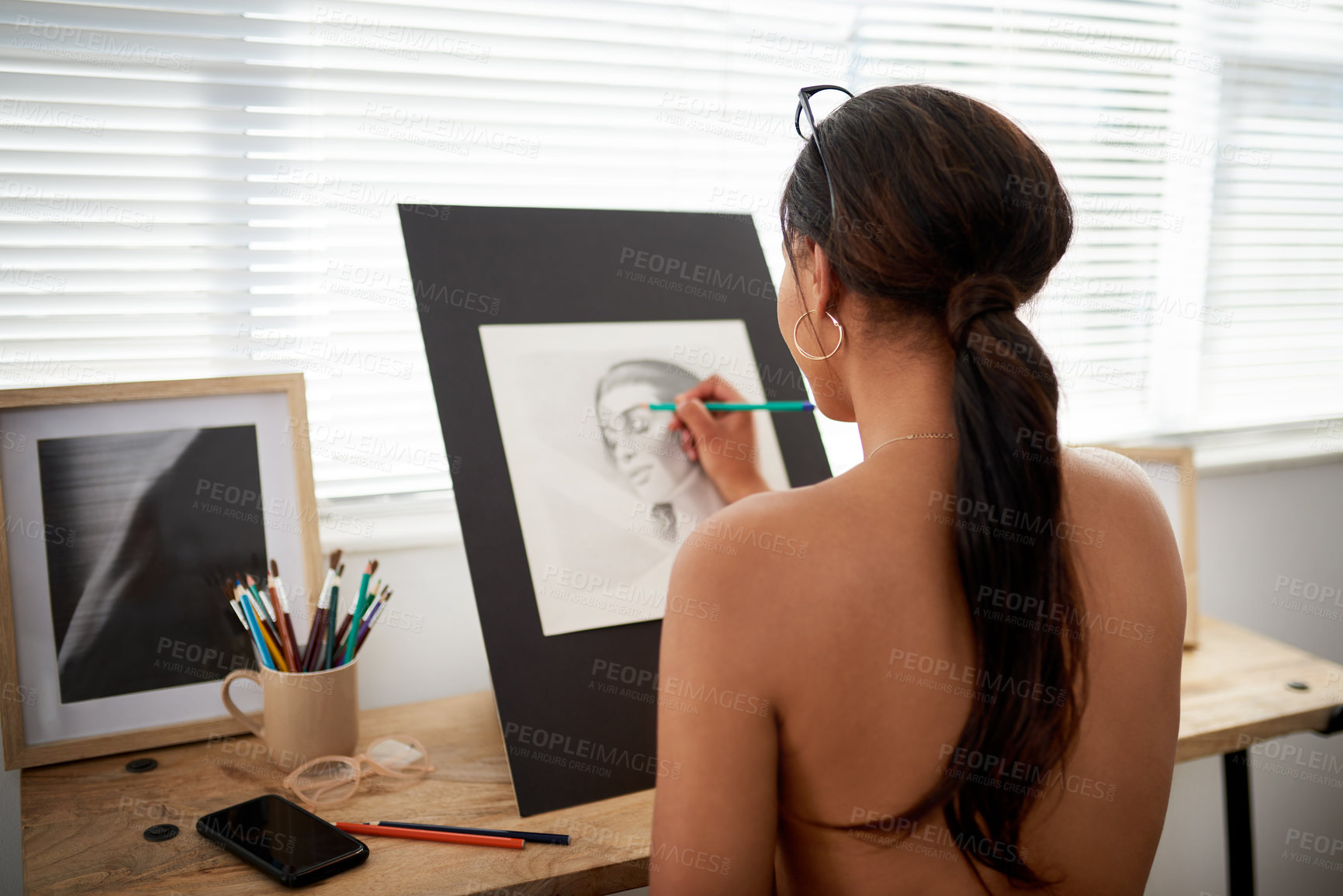 Buy stock photo Rearview of shot of an unrecognizable female artist drawing a portrait of a woman inside her studio
