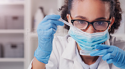 Buy stock photo Shot of a young scientist analysing samples in a lab