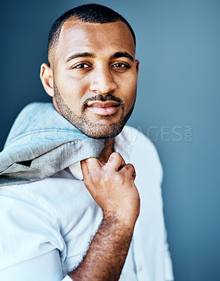 Buy stock photo Cropped portrait of a handsome young businessman standing alone and posing against a studio background