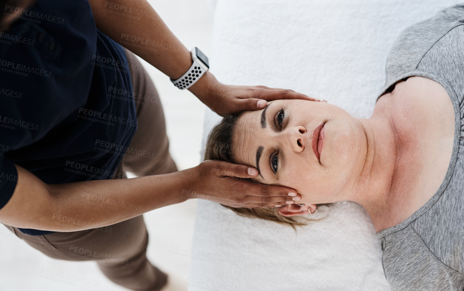 Buy stock photo Hands, head and woman in consultation with physiotherapist for help and spine assessment. Above, orthopedic and chiropractor holding client in exam for posture, joint and muscle problem diagnosis