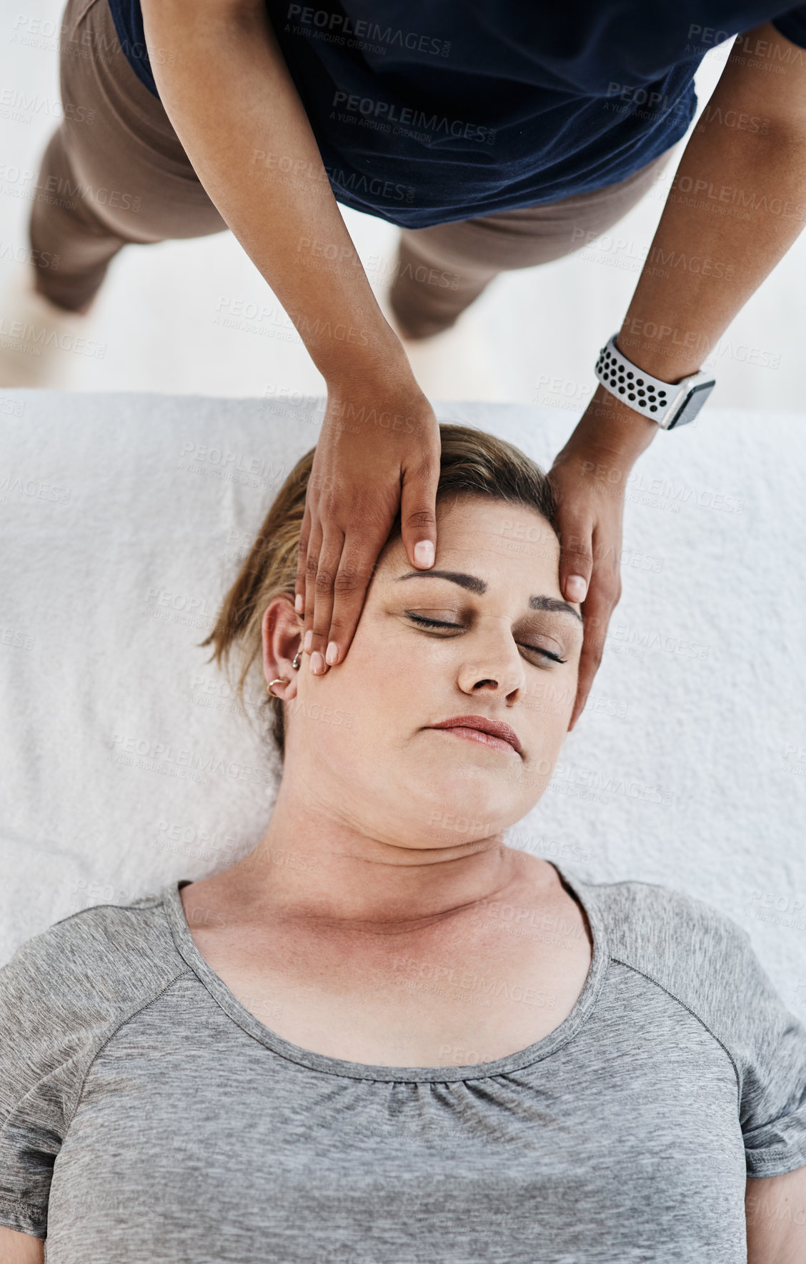 Buy stock photo Hands, physical therapy and massage head of woman for rehabilitation, relax or injury recovery above. Neck, chiropractor and healing client for health, wellness or help for pain relief with top view