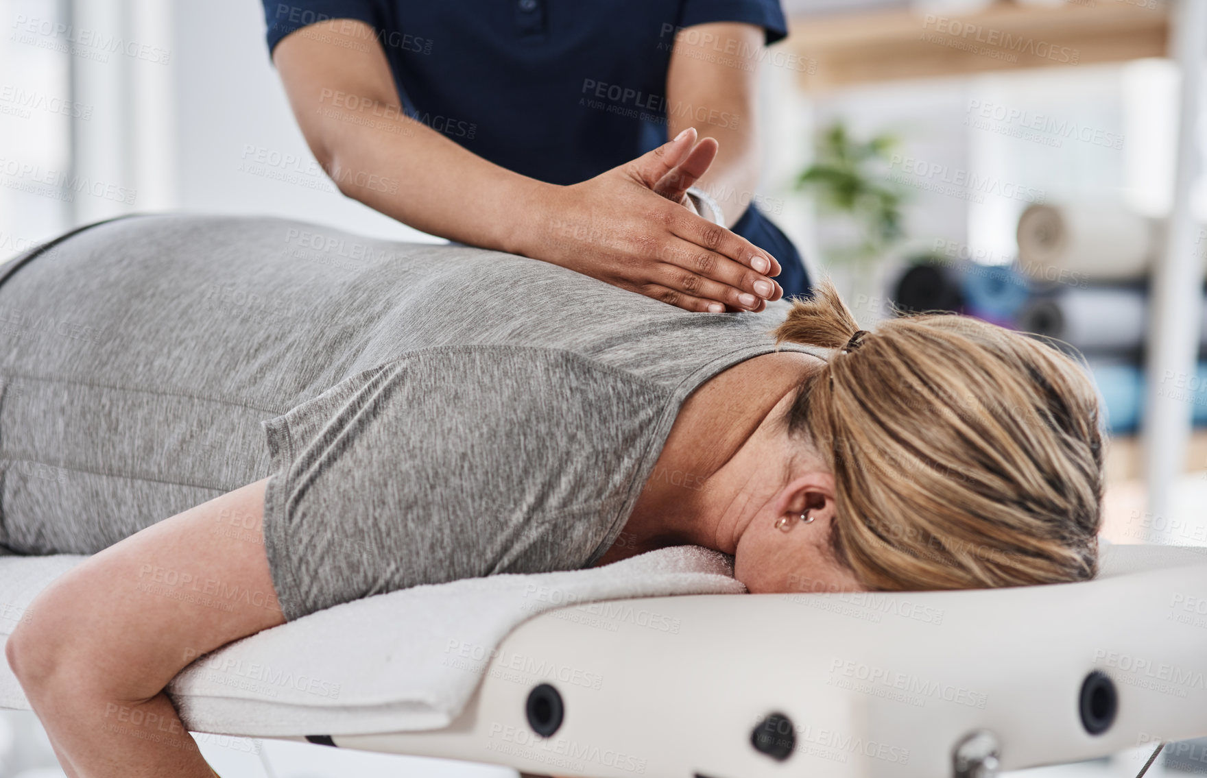 Buy stock photo Healing, hands and physiotherapist with person, spine and massage for pain of patient, healthcare and injury. Wellness, chiropractor and help for relief of tension, expert and physiotherapy in clinic