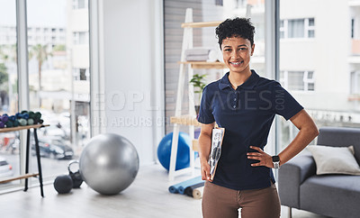 Buy stock photo Portrait of a young and confident physiotherapist posing inside her office at a clinic