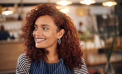 Buy stock photo Cropped shot an attractive young businesswoman standing alone in her cafe and smiling during the day