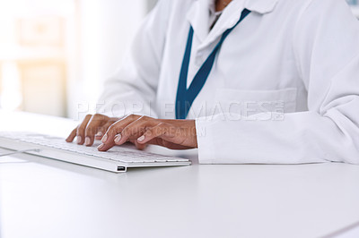 Buy stock photo Cropped shot of an unrecognizable young female scientist working on her computer in the laboratory