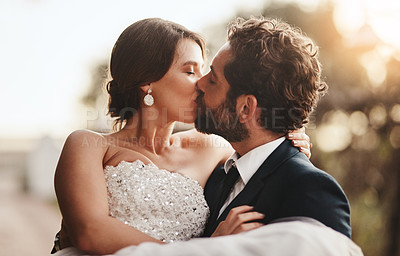 Buy stock photo Love, wedding and kiss with a couple outdoor on their marriage day together for romance or tradition. Event, celebration or married with a birde and groom kissing outside after their ceremony