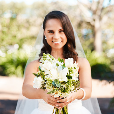 Buy stock photo Cropped portrait of a beautiful young bride smiling while holding a bouquet of flowers on her wedding day